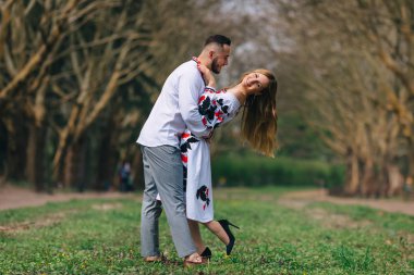 Damat gelini kucaklar ve sırtını büker. Işlemeli 