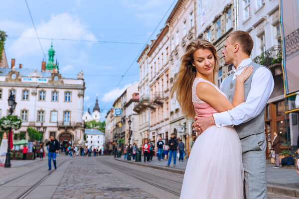 Profile of newlyweds is hugging each other on the background of 