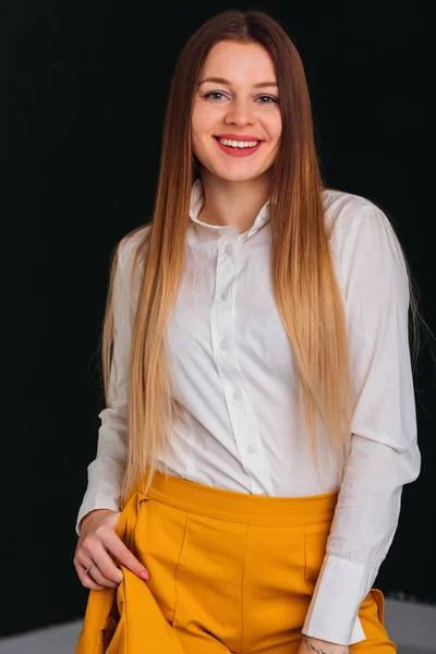 Young woman smiles cute and look at camera. white blouse and yel — Stock Photo, Image