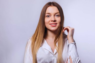  resmi beyaz bluz giyen ve arka üzerinde poz genç kadın