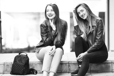 Sokakta poz verip kameraya bakan kızlar. stil deri jac