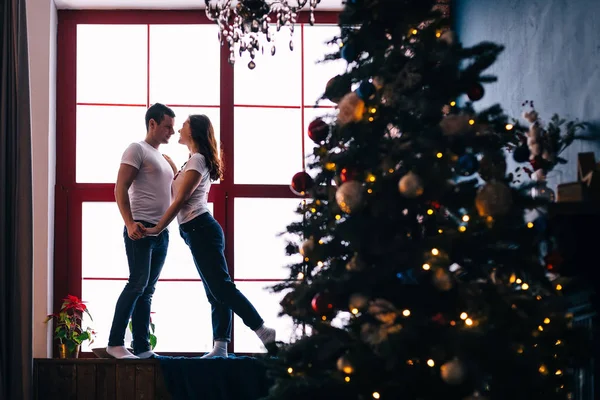 Cara e menina no peitoril da janela de mãos dadas e posando. Christm... — Fotografia de Stock