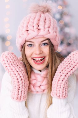 closeup of girl with freckles in pink hat, scarf and gloves. smi clipart