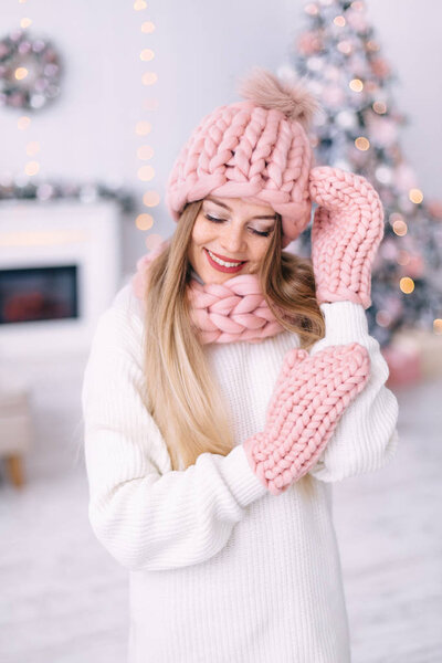 portrait of a girl in knitted winter clothes look down on a back