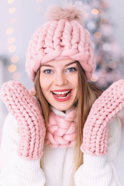 closeup of girl with freckles in pink hat, scarf and gloves. smi