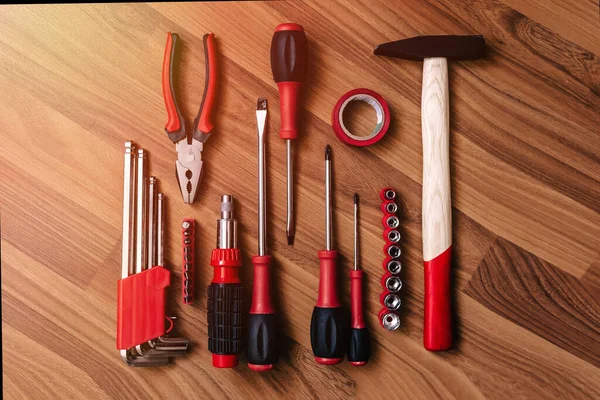 Set of tools on a wood floor. Top views with clear space.