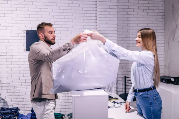 Serious Man Taking Bag Saleswoman Suit Store — Stock Photo, Image