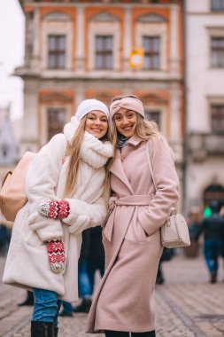 Şehrin sokaklarında sarılan iki şık kızın mutlu ve pozitif anları..