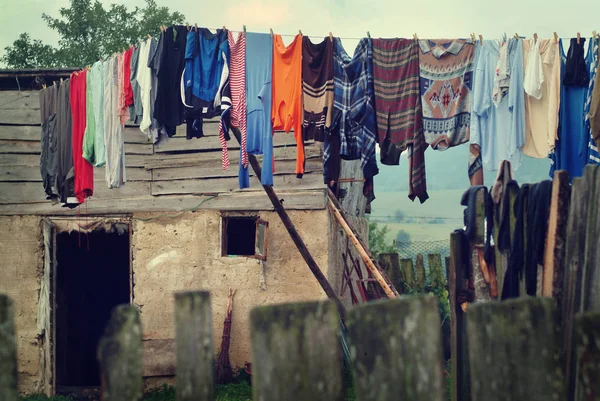 poor home with hanging clothes