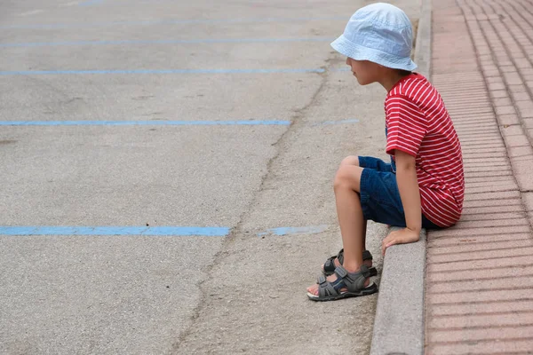 A gyermek ül egyedül a járdán — Stock Fotó