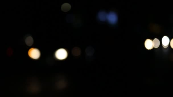夜のカラフルなボケのライトと都市交通の焦点車の外 — ストック動画