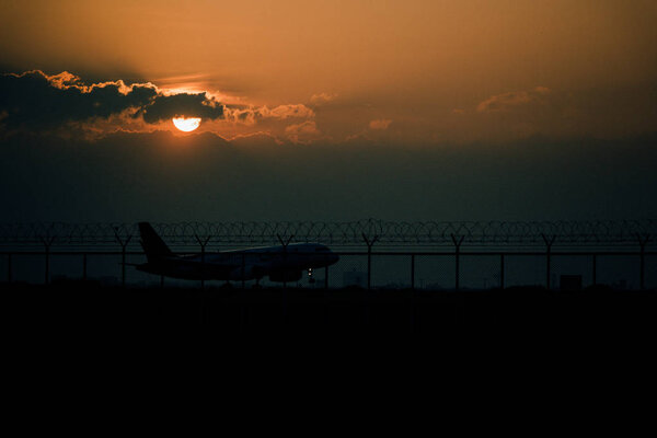 Runway, plane with evening sun