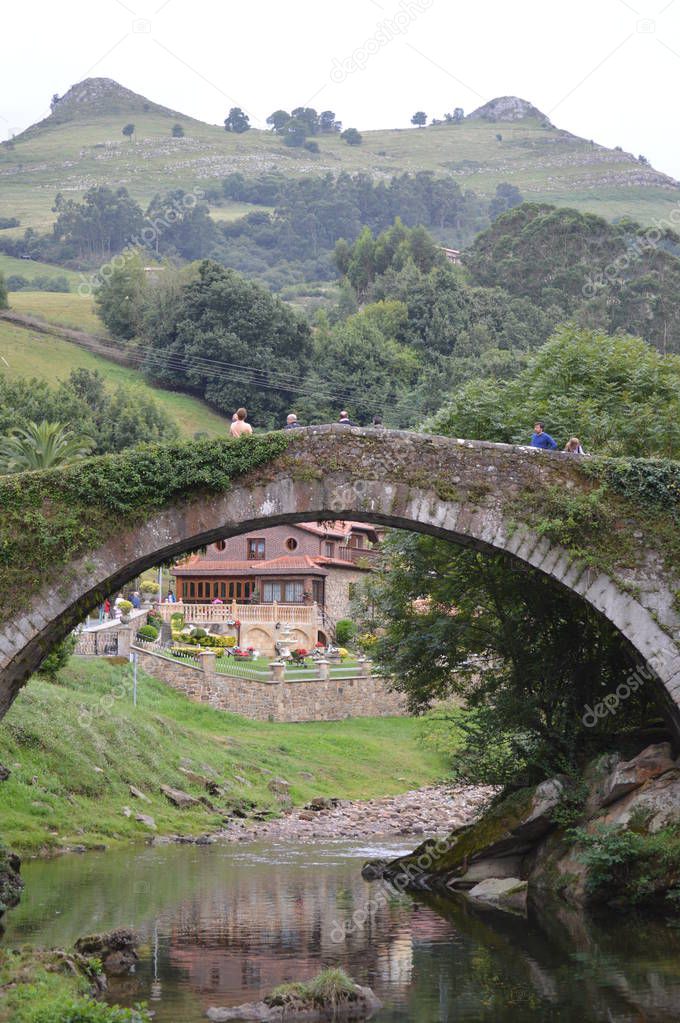 Beautiful Roman Bridge That Really Was Built In The 16th Century By Bartolome De La Hermosa In The Background The Tits In Lierganes. August 24, 2013. Lierganes, Cantabria. Vacation Nature Street Photography.