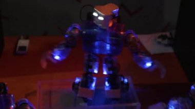 Robot dans eder, ellerini sallar ve kalçalarını hareket ettirir.