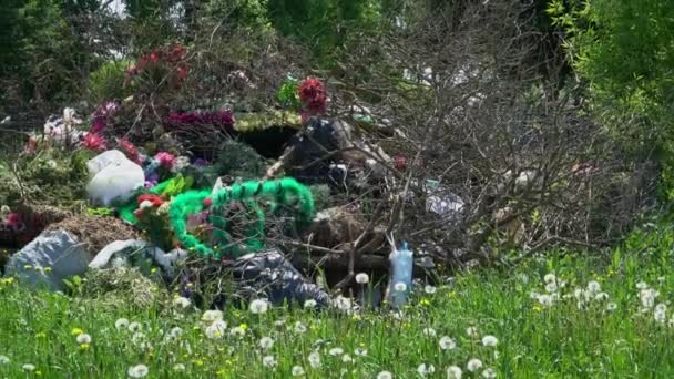 Panoramische foto van een stapel vuilnis met kransen en bloemen — Stockvideo