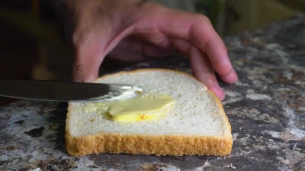 Burro spalmato sul pane per panini con un coltello da tavola — Video Stock