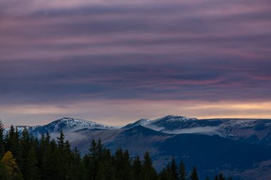 Transilvanya Alpleri 'nde sonbaharda renkli, ılık bir gün batımı.