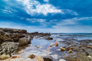 Rock formations on the Adriatic Sea in summer, under warm evening light clipart