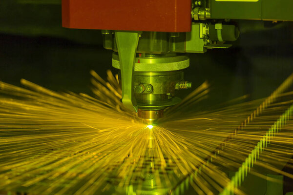 Close up Industrial laser and plasma cutting of steel sheet or metal sheet with sparks fly