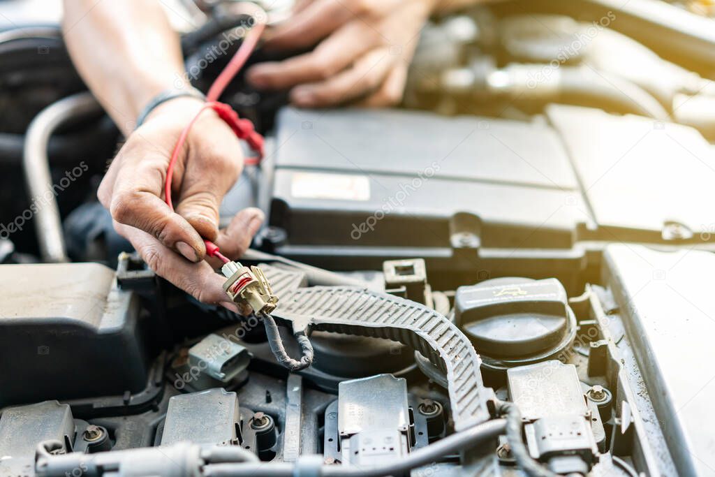 close up tool and hand of People or mechanic car repair during investigate cause of problem (electric system check) or working on automobile gasoline or diesel engine at garage