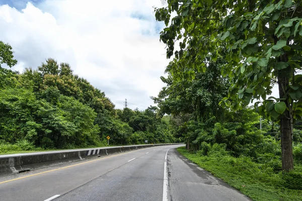 Beauty empty highway road with lamp post and tree on cloudy and blue sky day background