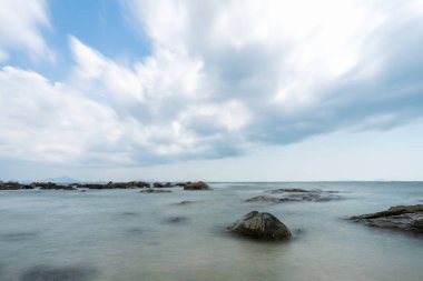Denizdeki resif ya da kaya ve Tayland 'da bulutlu güzel mavi gökyüzü kopyalanmış uzay (uzun pozlama))