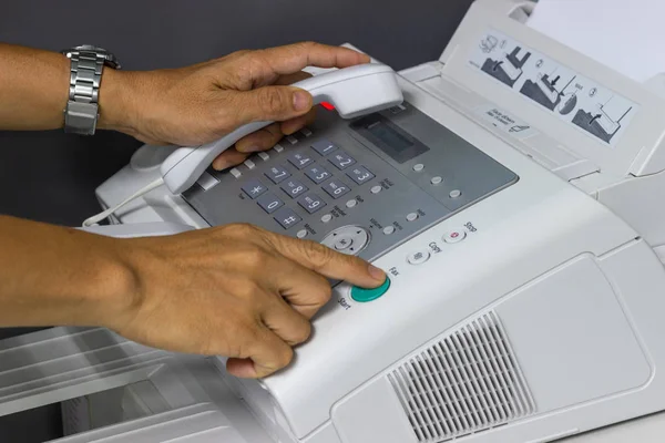 手マンは オフィスの Fax 機を使用しています ビジネス コンセプト — ストック写真