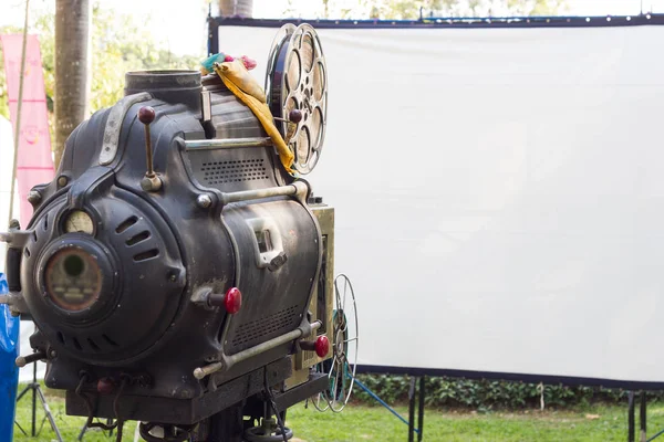 The old  analog rotary film movie projector at outdoor cinema movies theater for show people in the Park at Bangkok Thailand