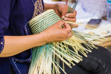 Motion Image - hand of woman holds The villagers took bamboo stripes to weave into different forms for daily use utensils of the communitys people in Bangkok Thailand, Thai handmade product.   clipart