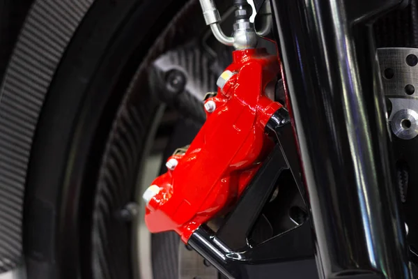 Close up motorcycle disc brake new modern red of Motorcycle, is brake system part of the motorcycle