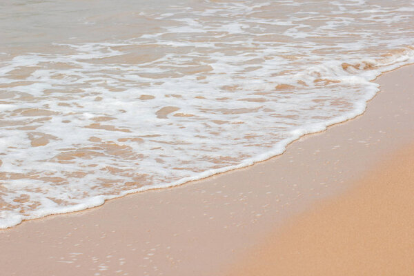 Soft wave of the blue ocean on the seashore of Thailand, copy space on the sand copy space