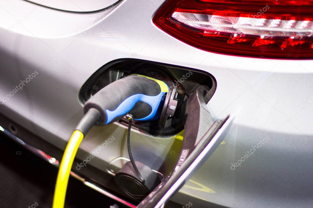 the charging the battery for the car new Automotive Innovations the power supply plugged into an electric car being charged.