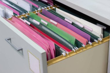 Files document of hanging file folders in a drawer in a whole pile of full papers, at work office Bangkok Thailand Business Concept  clipart