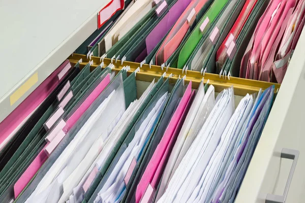 Files document of hanging file folders in a drawer in a whole pile of full papers, at work office Bangkok Thailand Business Concept