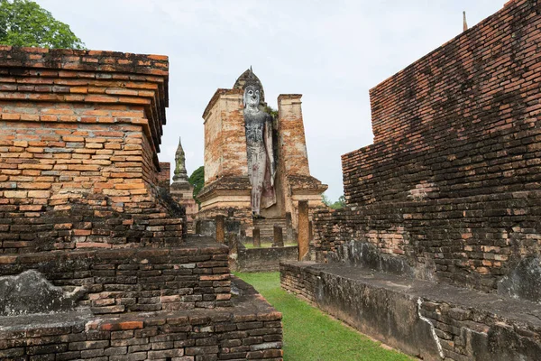 The old Buddha image on cement with ruins and ancient, Built in modern history in historical park is the UNESCO world heritage, Sukhothai Thailand.