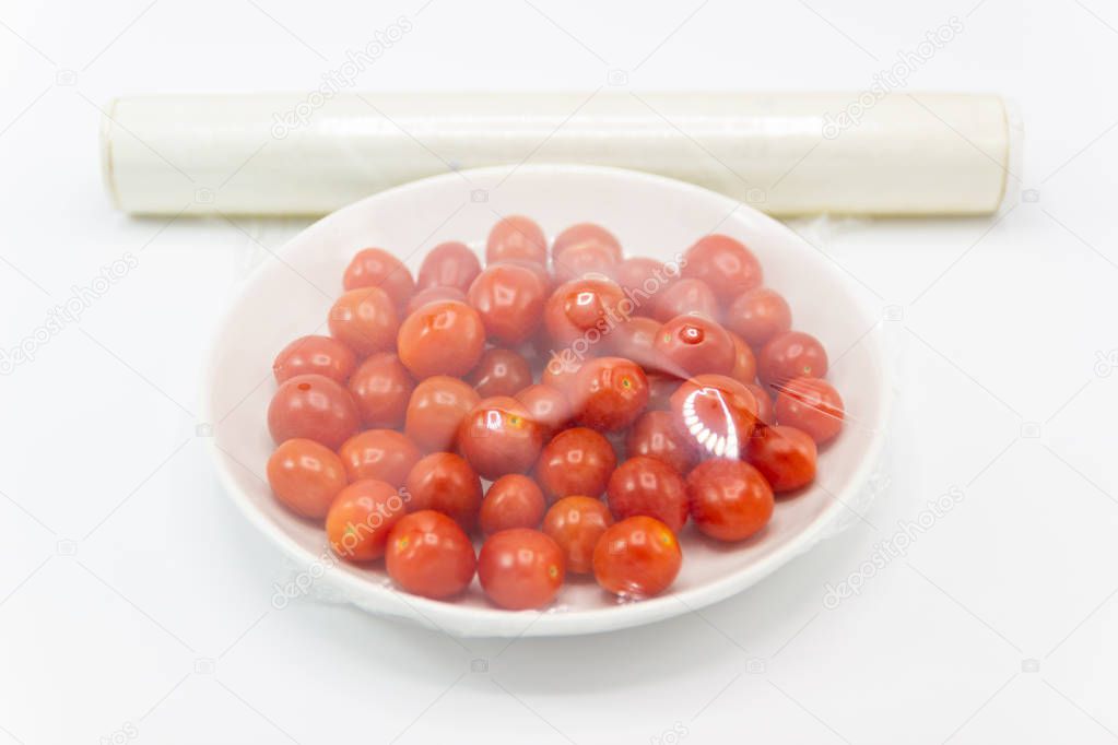 Fresh small tomato which are wrapped with plastic film preservation concept to maintain freshness. 