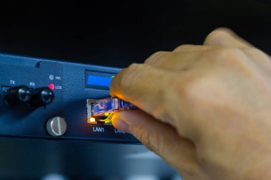 Sfp modül bağlantı Datacenter odasında kavramı iletişim teknolojisi bağlanmak için ağ kablolarını tutan adamın elini