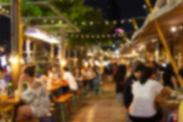 abstract blur image of night festival in a restaurant and The atmosphere is happy and relaxing with bokeh for background