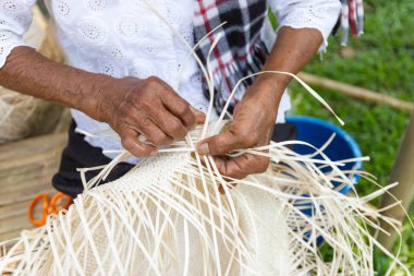 The villagers took bamboo stripes to weave into different forms for daily use utensils of the community people in Bangkok Thailand, Thai handmade product.   clipart