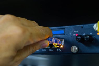 Sfp modül bağlantı Datacenter odasında kavramı iletişim teknolojisi bağlanmak için ağ kablolarını tutan adamın elini