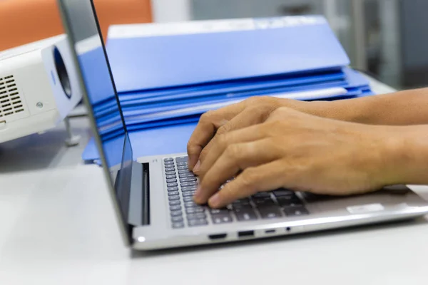 business man typing on laptop keyboard in work office