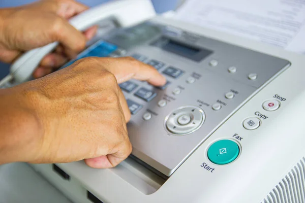 Hand man are using a fax machine in the office — Stock Photo, Image