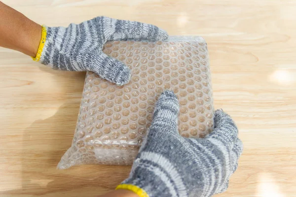 hand of man hold bubble wrap, for protection parcel product crac