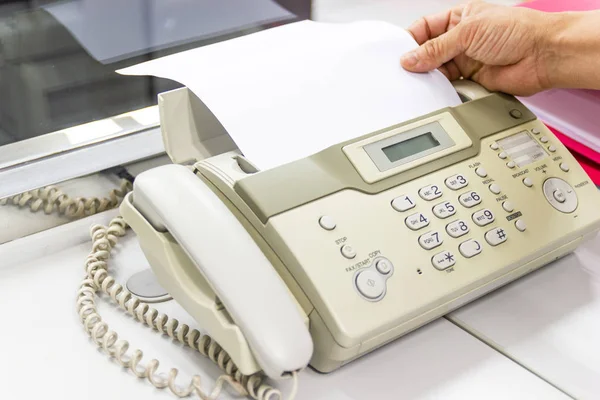 Ręka człowiek używa faksu w biurze — Zdjęcie stockowe