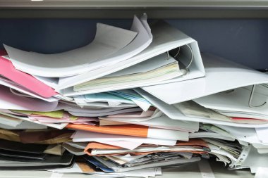 Çalışma ofisindeki dosya dolaplarında dağınık dosya ve ofis malzemeleri 