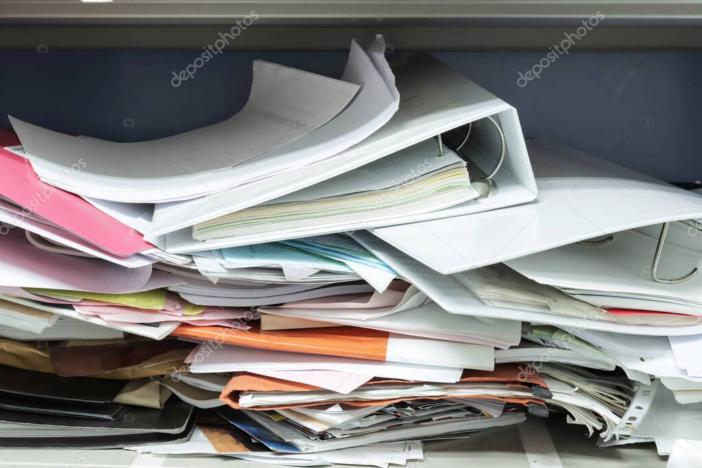 Messy file document and Office Supplies in filing cabinets at work office 