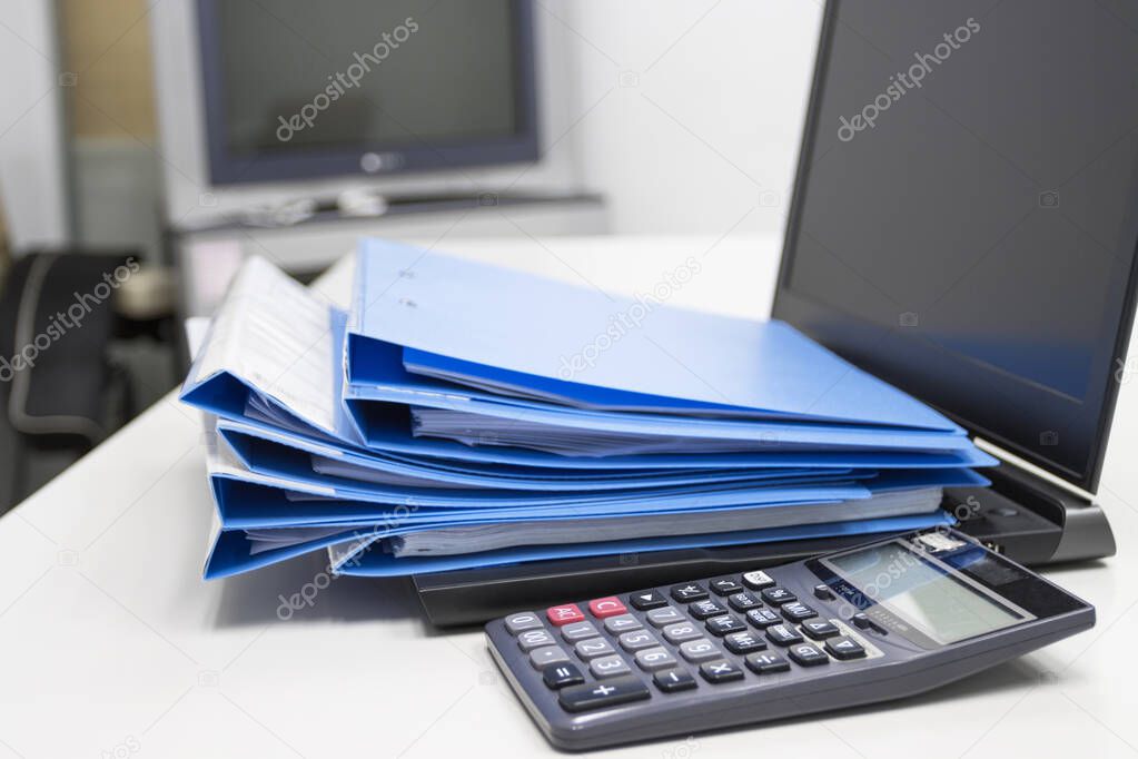file folder with documents and  Calculator With Notebook on table in meeting room 