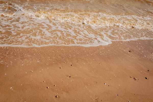 White waves of Azove sea on a red sand. — Stock Image White waves of Azove sea on a red sand. Stock Photo