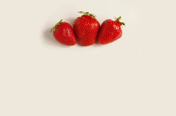 Three fresh red strawberries on white background — Stock Photo, Image