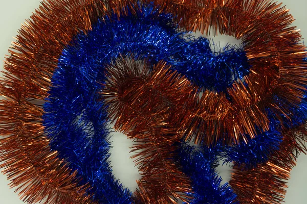 The background of Christmas tinsel blue and orange